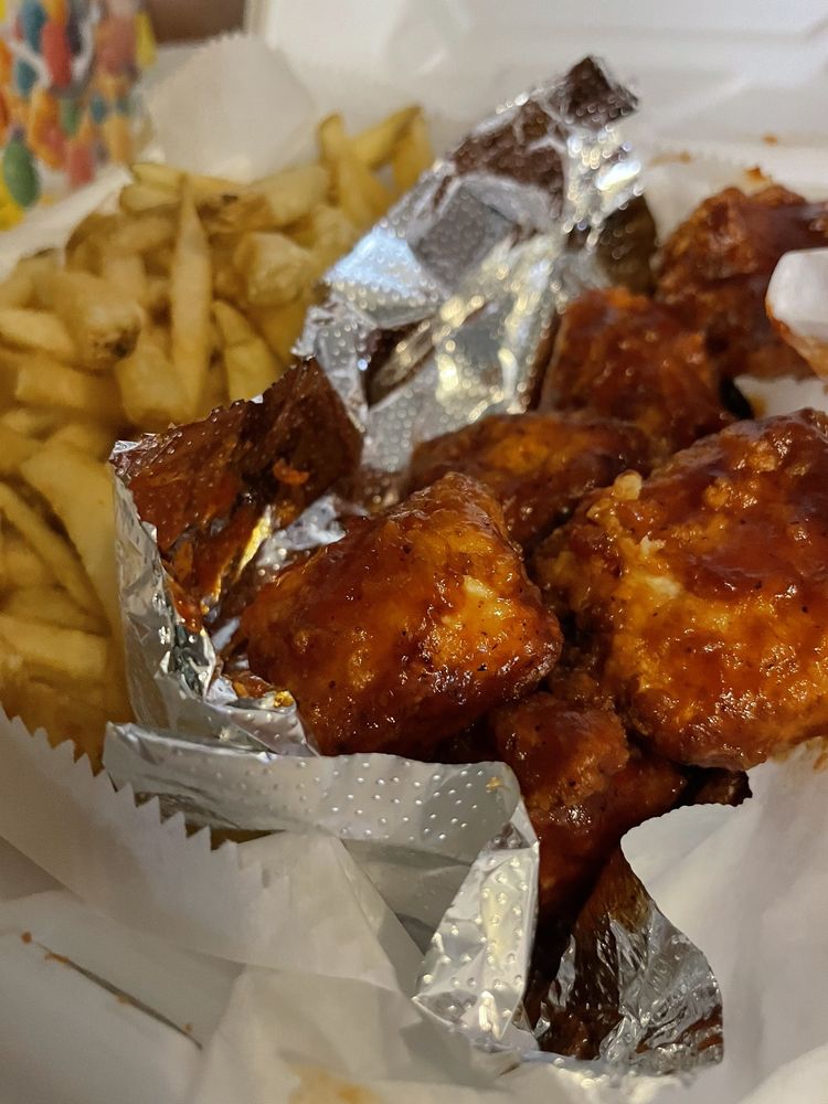 Large, juicy, honey-barbecued covered, boneless wings and Parmesan fries from Wing Doozy in Grand Rapids. 